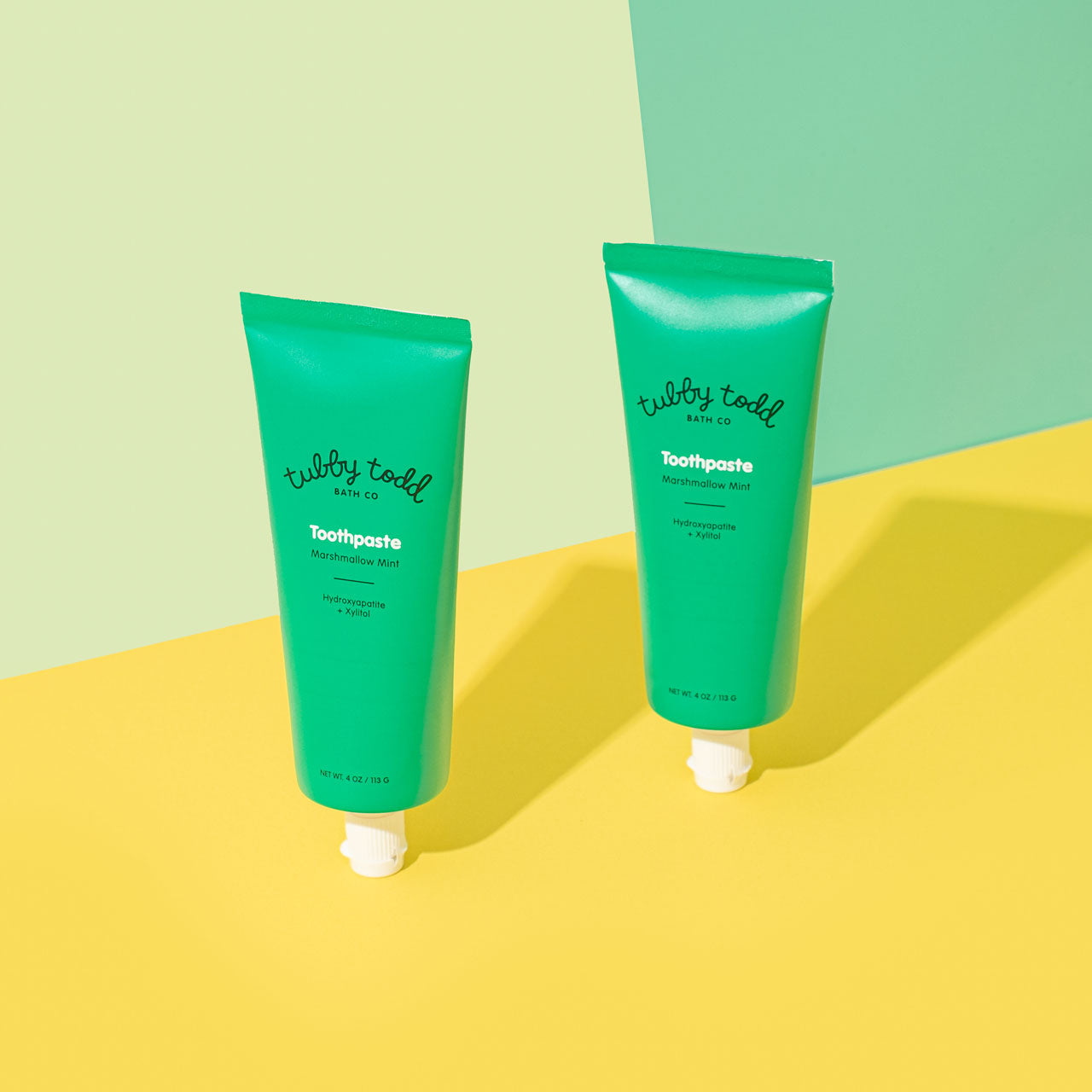 Hydroxyapatite Toothpaste standing on green and yellow studio background